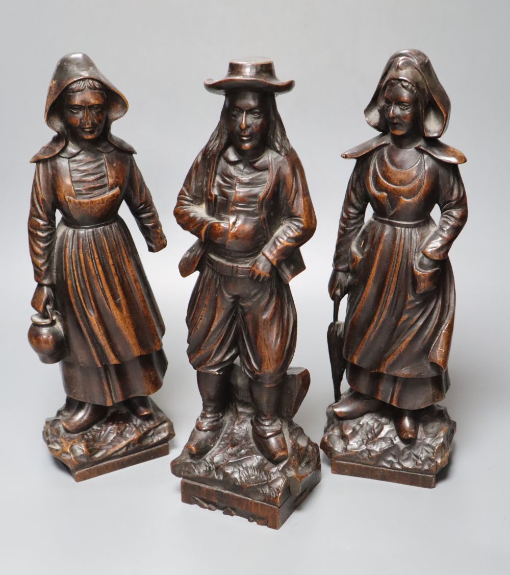 A set of three 19th century Dutch walnut figures of puritans, height 34cm